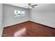Cozy bedroom with hardwood flooring, a ceiling fan, and a bright window view at 1750 E Mateo Cir # 103, Mesa, AZ 85204