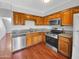Well-equipped kitchen with stainless steel appliances, wood cabinets, and granite countertops at 1750 E Mateo Cir # 103, Mesa, AZ 85204