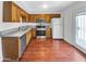 Kitchen features stainless steel appliances, wood cabinets, and hardwood floors at 1750 E Mateo Cir # 103, Mesa, AZ 85204