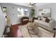 Cozy living room featuring a neutral sofa, chair, round table, and stylish decor at 1750 E Mateo Cir # 103, Mesa, AZ 85204