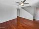 Spacious living room featuring hardwood floors, a ceiling fan, and a staircase at 1750 E Mateo Cir # 103, Mesa, AZ 85204