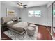 Staged main bedroom with a tufted headboard, a light colored rug, and ample natural light at 1750 E Mateo Cir # 103, Mesa, AZ 85204