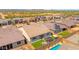 Aerial view of a home with a landscaped backyard, gazebo, and sparkling pool in a desert community at 17597 W Red Fox Rd, Surprise, AZ 85387
