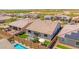 An aerial view of a backyard with a pool, patio furniture, green grass and desert landscaping at 17597 W Red Fox Rd, Surprise, AZ 85387