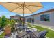 Outdoor patio area features comfortable seating, an umbrella, and a charming gazebo with a swing at 17597 W Red Fox Rd, Surprise, AZ 85387