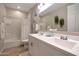 Bright bathroom featuring a dual sink vanity with white cabinetry and a shower-tub combo at 17597 W Red Fox Rd, Surprise, AZ 85387