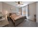Cozy bedroom featuring a ceiling fan, carpet flooring and a queen bed at 17597 W Red Fox Rd, Surprise, AZ 85387
