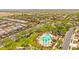 Aerial view highlighting a community pool with palm trees, desert landscaping, and lounge chairs at 17597 W Red Fox Rd, Surprise, AZ 85387