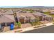 Aerial view of home featuring desert landscaping, a brick driveway, and a 3-car garage at 17597 W Red Fox Rd, Surprise, AZ 85387