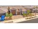 Aerial view of a beautifully landscaped home featuring a brick driveway and desert landscaping at 17597 W Red Fox Rd, Surprise, AZ 85387