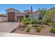 Beautiful single-story home boasting desert landscaping and a three-car garage at 17597 W Red Fox Rd, Surprise, AZ 85387