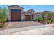 Stunning home showcasing a three-car garage, tile roof, and well-manicured landscaping at 17597 W Red Fox Rd, Surprise, AZ 85387