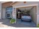 Spacious three-car garage with an RV and a car at 17597 W Red Fox Rd, Surprise, AZ 85387