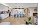 Open kitchen design with a large island, white cabinetry, and modern pendant lighting at 17597 W Red Fox Rd, Surprise, AZ 85387