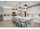 Modern kitchen with a large island, bar stools, and a spacious layout at 17597 W Red Fox Rd, Surprise, AZ 85387