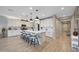 Gourmet kitchen featuring a center island with bar seating, bright cabinetry, and wood flooring at 17597 W Red Fox Rd, Surprise, AZ 85387