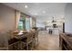 Open floor plan connects the dining area, living room, and kitchen island, creating an inviting and functional space at 17597 W Red Fox Rd, Surprise, AZ 85387