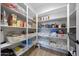 Walk-in pantry with ample shelving, organized storage baskets, and plenty of space for all your kitchen essentials at 17597 W Red Fox Rd, Surprise, AZ 85387