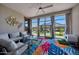 Relaxing sunroom with comfortable seating and large windows overlooking a beautifully landscaped backyard with gazebo at 17597 W Red Fox Rd, Surprise, AZ 85387