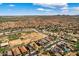 An aerial view that highlights homes in a beautiful neighborhood and desert landscape with distant mountain views at 18132 W Cardinal Dr, Goodyear, AZ 85338