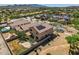 An aerial view showcasing a backyard with a firepit and nearby homes fitted with solar panels at 18132 W Cardinal Dr, Goodyear, AZ 85338