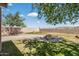 Back yard featuring a fire pit, green lawn, and a block wall for privacy at 18132 W Cardinal Dr, Goodyear, AZ 85338