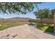 Back yard featuring a fire pit, green lawn, and a block wall for privacy at 18132 W Cardinal Dr, Goodyear, AZ 85338