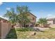 Expansive backyard featuring a fire pit, mature tree, and patio space, creating a relaxing outdoor oasis at 18132 W Cardinal Dr, Goodyear, AZ 85338