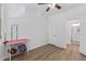 Clean bedroom with neutral walls, wood laminate floor, white trim and doors, and view into the bathroom at 18132 W Cardinal Dr, Goodyear, AZ 85338