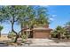 Attractive two-story home with a tan facade, tiled roof, desert landscaping, and an attached two car garage at 18132 W Cardinal Dr, Goodyear, AZ 85338