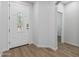 Bright, spacious foyer features a white decorative door with glass detail and clean, neutral walls at 18132 W Cardinal Dr, Goodyear, AZ 85338