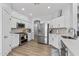 Charming kitchen with stainless steel appliances, white cabinets, and wood-look flooring at 18132 W Cardinal Dr, Goodyear, AZ 85338