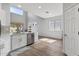 Bright kitchen features white cabinetry, stainless steel appliances, luxury vinyl plank flooring, and natural light at 18132 W Cardinal Dr, Goodyear, AZ 85338
