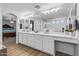 Bright main bathroom featuring double sinks, a large mirror, and a walk-in shower at 18132 W Cardinal Dr, Goodyear, AZ 85338
