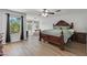 Spacious main bedroom suite boasting hardwood floors, large windows, and luxury furnishings at 18132 W Cardinal Dr, Goodyear, AZ 85338