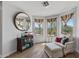 Bright sitting area featuring a chair with ottoman, large windows, and a bookshelf at 18132 W Cardinal Dr, Goodyear, AZ 85338