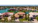 Expansive aerial view of a waterfront home, showcasing its tile roof and lush landscaping at 1834 E Willow Tree Ct, Gilbert, AZ 85234
