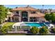 Stunning aerial view of luxurious waterfront home with pool, spa, and putting green at 1834 E Willow Tree Ct, Gilbert, AZ 85234