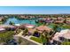 Stunning aerial view of waterfront homes with tile roofs and lush landscaping near a lake at 1834 E Willow Tree Ct, Gilbert, AZ 85234