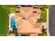 Aerial of mediterranean-style home with pool, spa, putting green, and tile roof at 1834 E Willow Tree Ct, Gilbert, AZ 85234