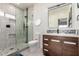 Modern bathroom with walk-in shower, patterned backsplash, and wooden vanity at 1834 E Willow Tree Ct, Gilbert, AZ 85234