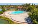 Aerial view of a beach featuring white sand, clear water, lounge chairs, and palm trees for a relaxed atmosphere at 1834 E Willow Tree Ct, Gilbert, AZ 85234