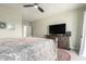 Bedroom with carpet, ceiling fan, large tv, and neutral walls at 1834 E Willow Tree Ct, Gilbert, AZ 85234