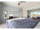 Bright bedroom with carpet, ceiling fan, large mirror, and desk space at 1834 E Willow Tree Ct, Gilbert, AZ 85234