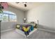 Bright bedroom with neutral walls, carpet, and arched window at 1834 E Willow Tree Ct, Gilbert, AZ 85234