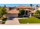 Stunning home features a tile roof, manicured lawn, and an attached three-car garage at 1834 E Willow Tree Ct, Gilbert, AZ 85234