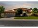 Elegant home showcasing a tile roof, manicured lawn, and a well-maintained garden at 1834 E Willow Tree Ct, Gilbert, AZ 85234