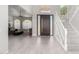 Inviting foyer with wood floors, a modern front door, and a staircase leading to the upper level at 1834 E Willow Tree Ct, Gilbert, AZ 85234