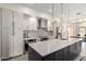 Stunning kitchen featuring white cabinets, stainless steel appliances, an island and modern light fixtures at 1834 E Willow Tree Ct, Gilbert, AZ 85234