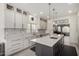 Updated kitchen with a large island, modern backsplash, stainless appliances, and stylish lighting at 1834 E Willow Tree Ct, Gilbert, AZ 85234